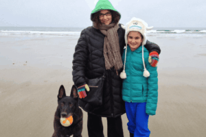 dog family activities walking on beach